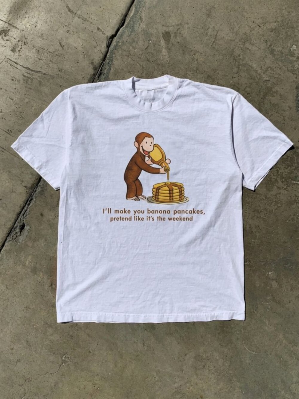 Curious George Peeling a Banana Modern Cartoon with Logo Toddler T-shirt